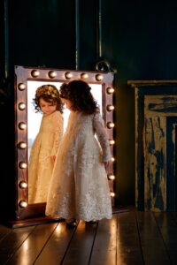 A baby girl riflected in mirror. customized baby girl dress