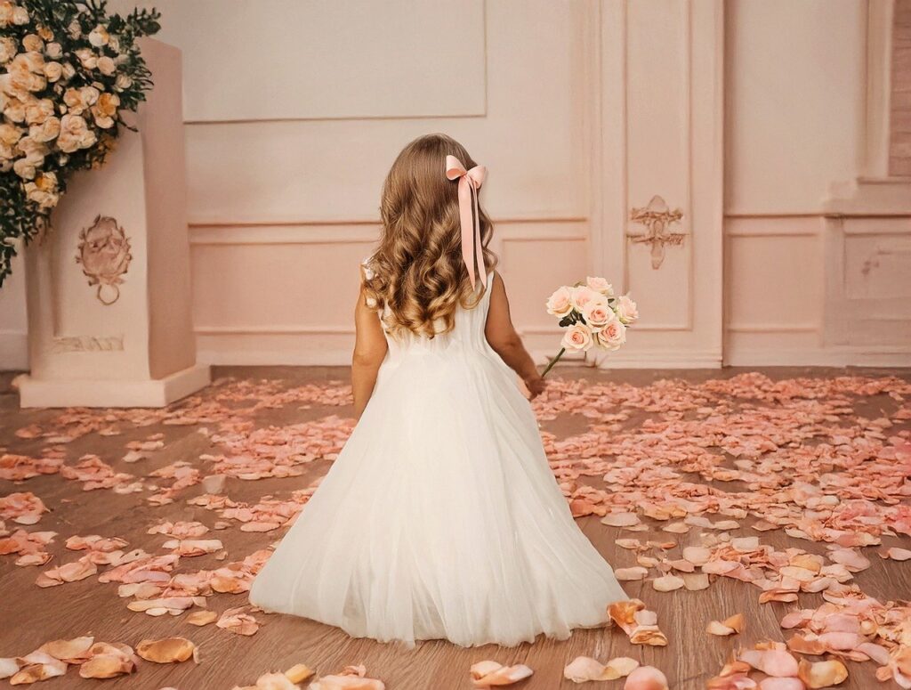 baby girl wear a party wear dress handled with a flower bouquet
